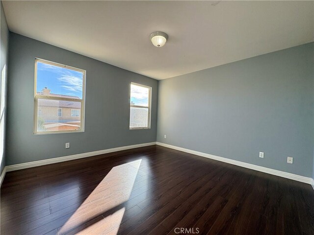 empty room featuring dark hardwood / wood-style flooring