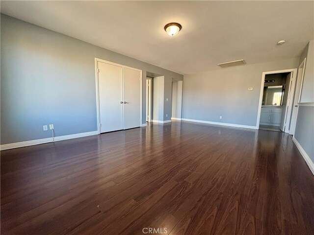 spare room featuring dark hardwood / wood-style flooring