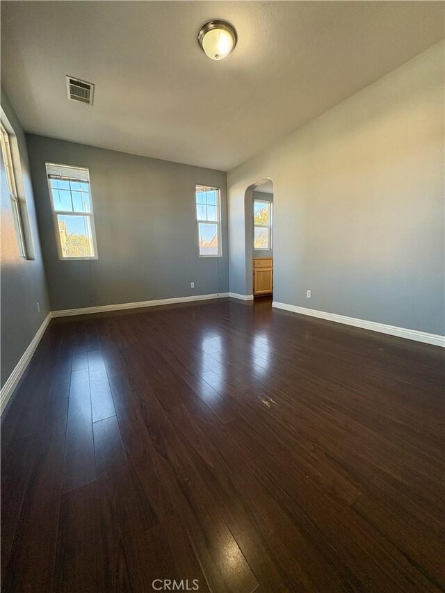 spare room featuring dark wood-type flooring