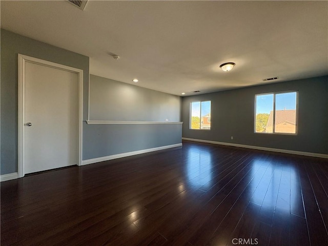 spare room with dark hardwood / wood-style floors