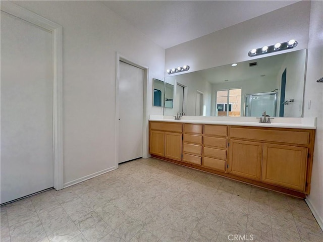 bathroom featuring vanity and a shower with door