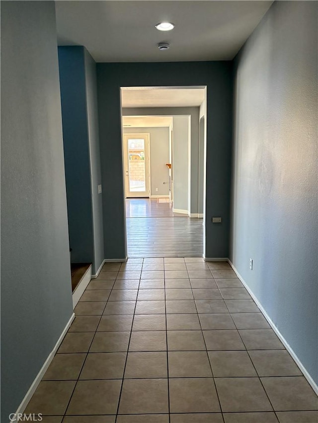 hall with tile patterned floors