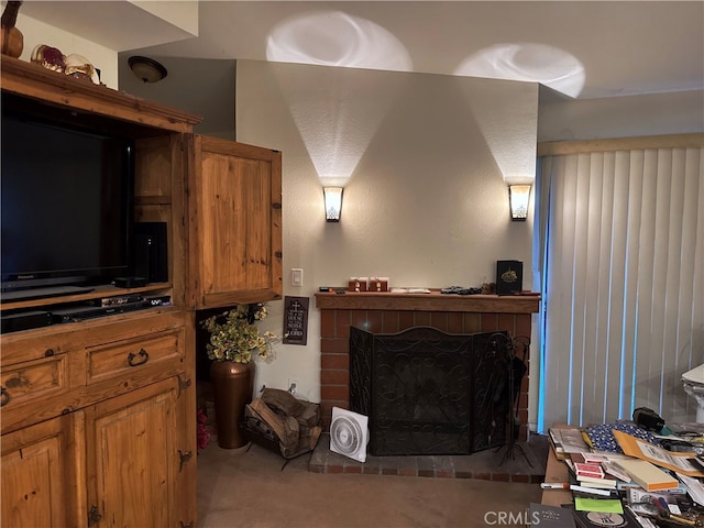 carpeted living room with a brick fireplace