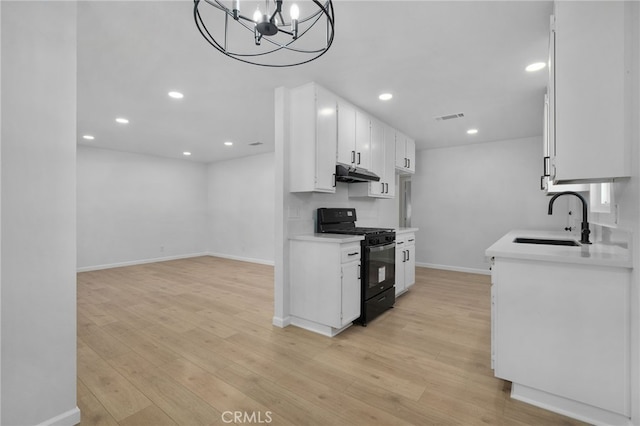 kitchen featuring white cabinetry, sink, black range with gas cooktop, and light hardwood / wood-style floors