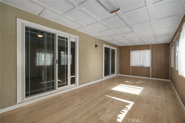 unfurnished sunroom with coffered ceiling