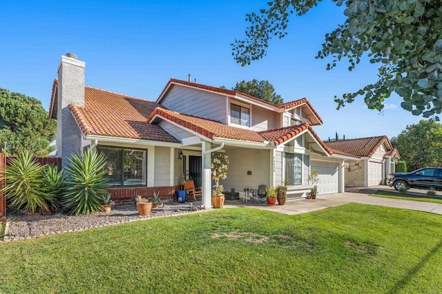 view of front of home with a garage and a front lawn