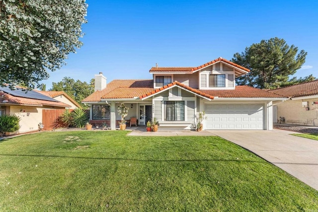 mediterranean / spanish-style house featuring a front yard and a garage