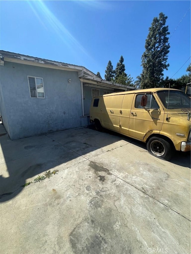 view of property exterior featuring stucco siding and driveway