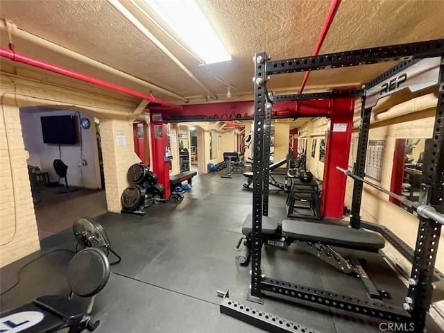 gym featuring a textured ceiling