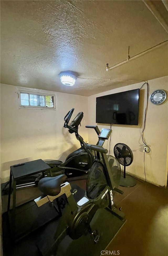 exercise area featuring a textured ceiling