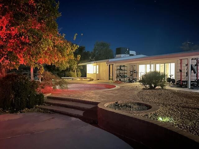 back house at twilight with a patio