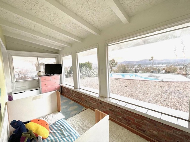 sunroom / solarium featuring baseboard heating and beam ceiling