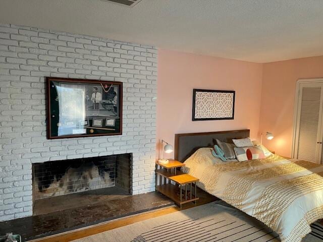 bedroom featuring a brick fireplace