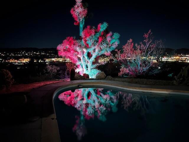 view of pool at night