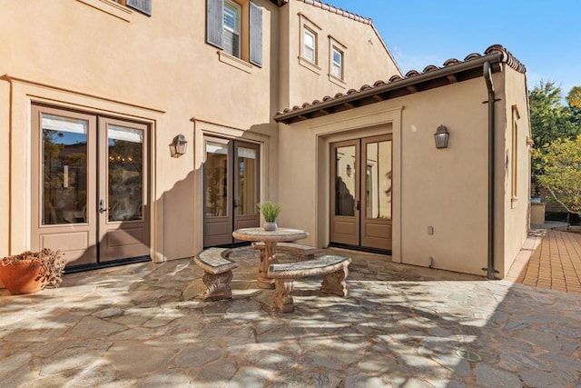 rear view of house featuring a patio area and french doors