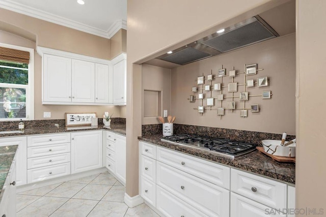 kitchen with stainless steel gas stovetop, white cabinetry, crown molding, and exhaust hood