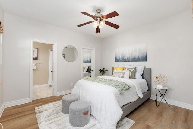 bedroom featuring wood-type flooring, connected bathroom, and ceiling fan