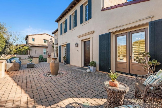 view of patio featuring an outdoor living space and french doors