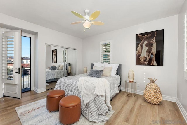 bedroom with access to exterior, light hardwood / wood-style floors, a closet, and ceiling fan