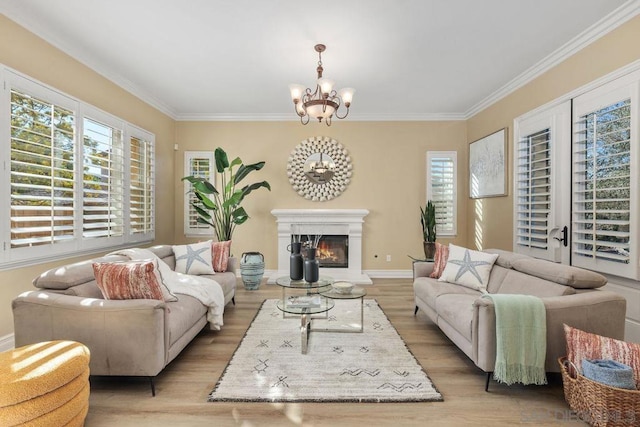 living room featuring a chandelier, light hardwood / wood-style flooring, and crown molding