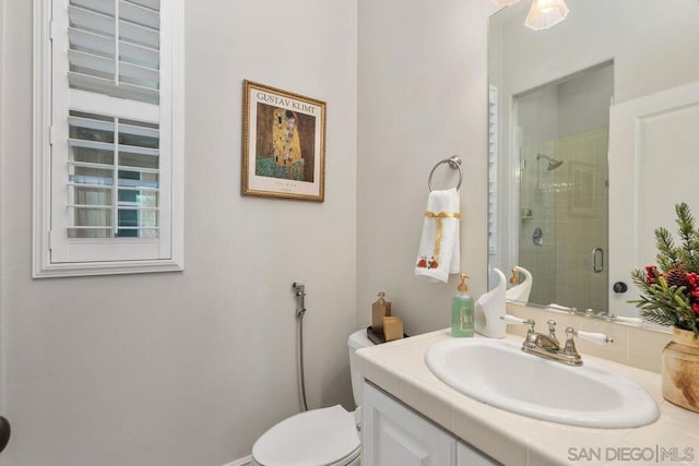 bathroom with vanity, toilet, and an enclosed shower