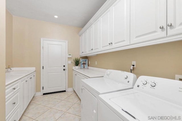 laundry room with cabinets, separate washer and dryer, sink, and light tile patterned floors