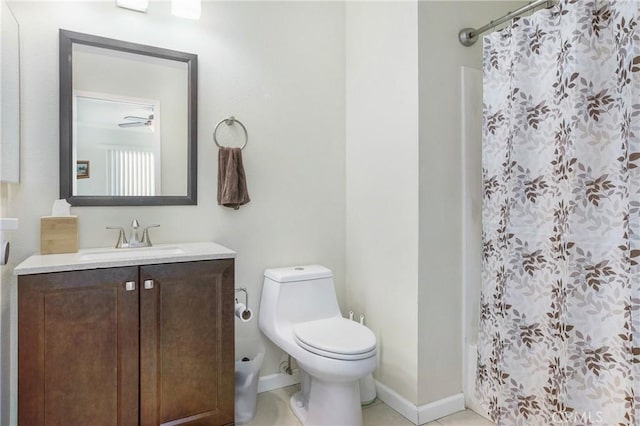 bathroom featuring tile patterned flooring, vanity, toilet, and walk in shower