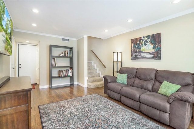 living room with wood-type flooring and crown molding