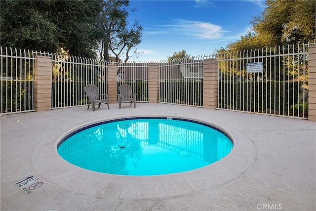 view of swimming pool with a patio area