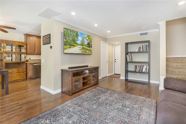 living room featuring ornamental molding, ceiling fan, and dark wood-type flooring