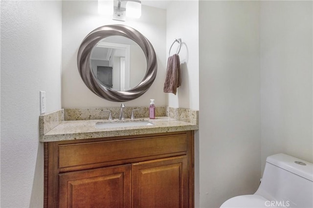 bathroom with vanity and toilet