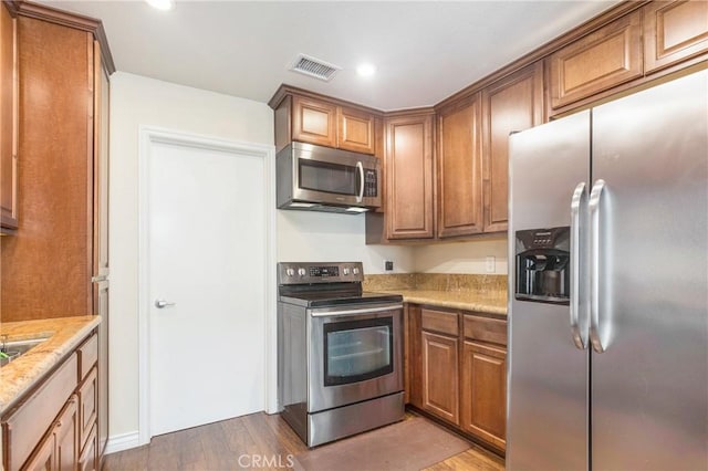 kitchen featuring wood-type flooring and stainless steel appliances