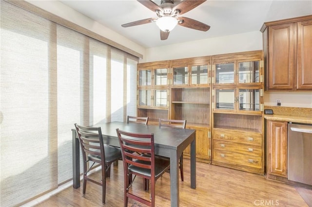 dining room with ceiling fan and light hardwood / wood-style flooring