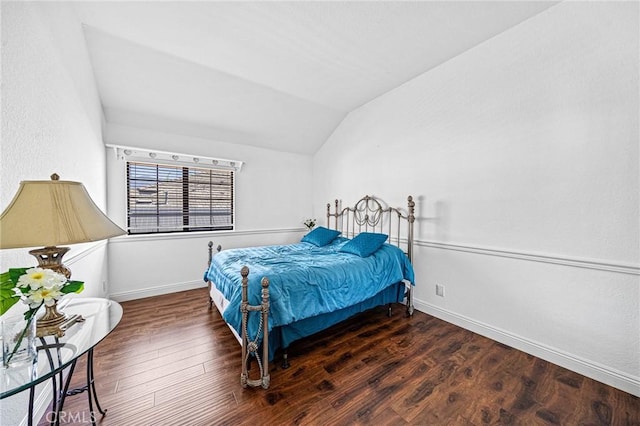 bedroom with dark hardwood / wood-style flooring and lofted ceiling