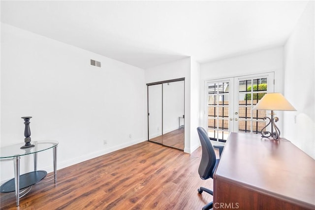 home office featuring wood-type flooring and french doors