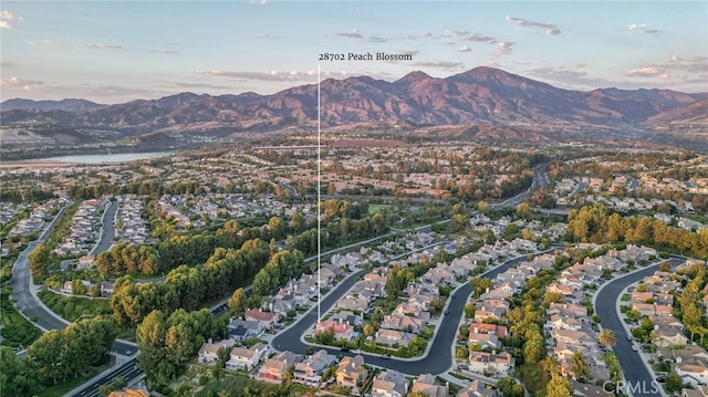 aerial view at dusk featuring a mountain view