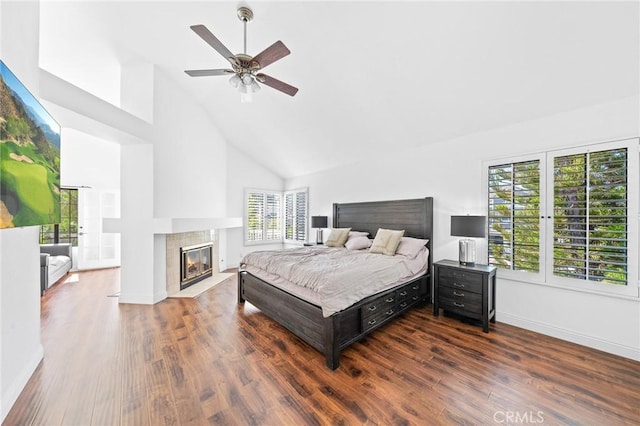 bedroom with ceiling fan, dark wood-type flooring, and high vaulted ceiling