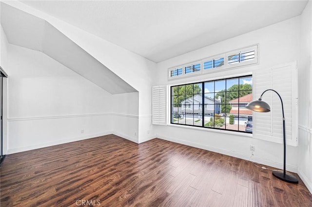 bonus room with dark hardwood / wood-style flooring