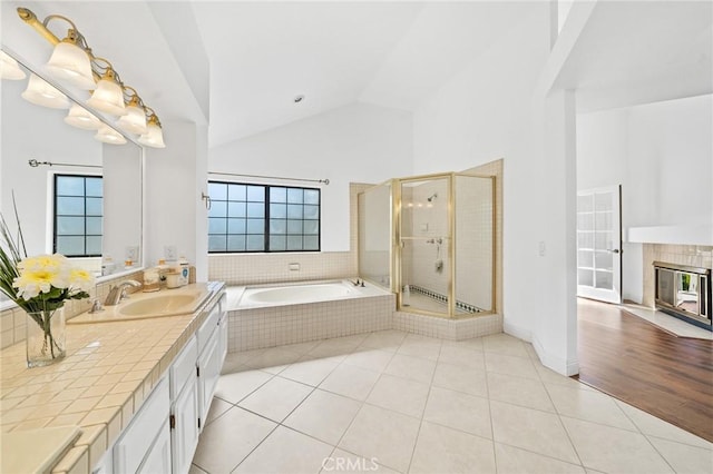 bathroom featuring separate shower and tub, tile patterned floors, vanity, and high vaulted ceiling