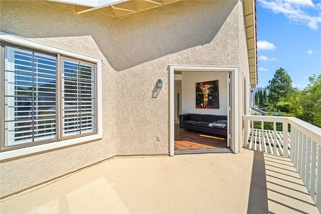 view of exterior entry featuring a balcony