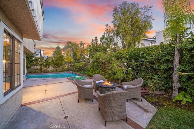 patio terrace at dusk with an outdoor fire pit