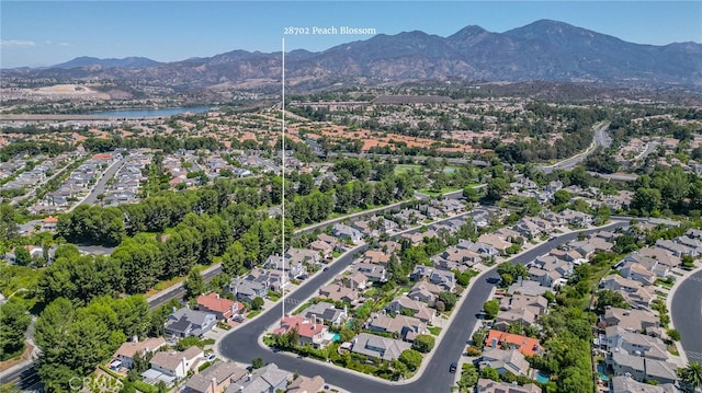 drone / aerial view with a residential view and a water and mountain view