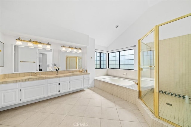 bathroom with tile patterned flooring, vanity, separate shower and tub, and lofted ceiling