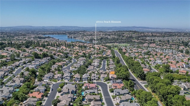 birds eye view of property featuring a water and mountain view