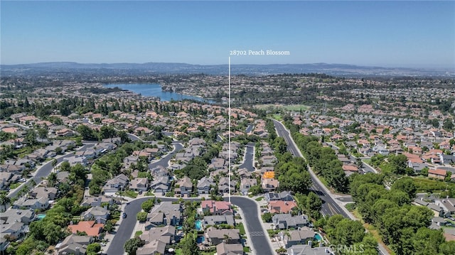 birds eye view of property with a water view and a residential view