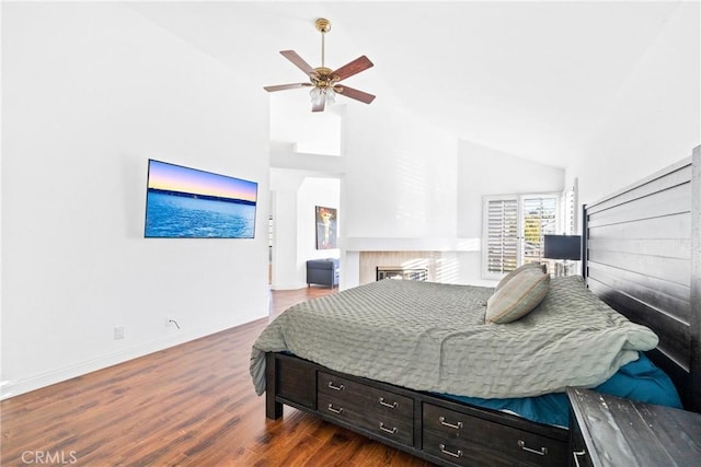 bedroom with high vaulted ceiling, dark wood finished floors, baseboards, and ceiling fan