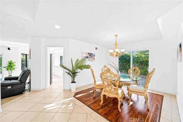 dining room with light tile patterned floors, baseboards, a chandelier, and a wealth of natural light