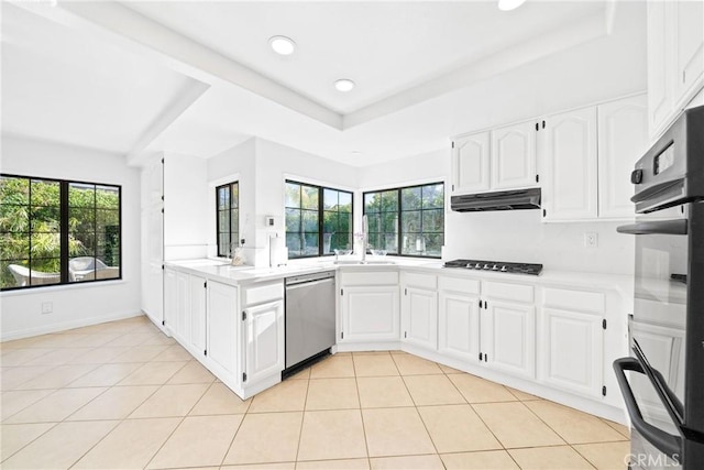 kitchen with light tile patterned floors, dishwasher, light countertops, under cabinet range hood, and gas cooktop