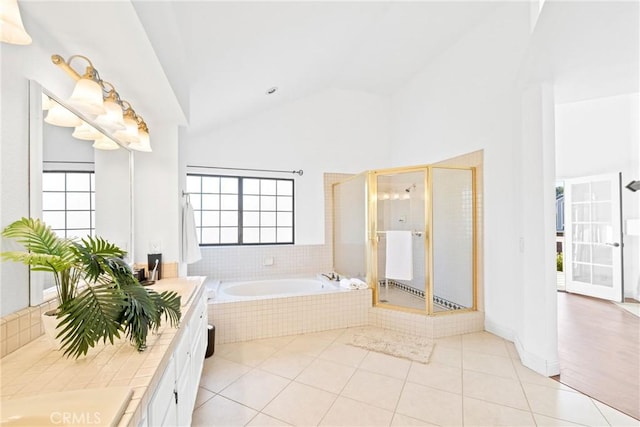 bathroom featuring a stall shower, a garden tub, vanity, and tile patterned floors