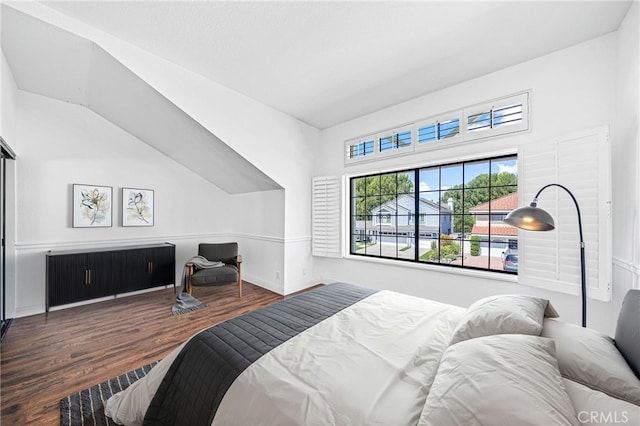 bedroom with wood finished floors and baseboards